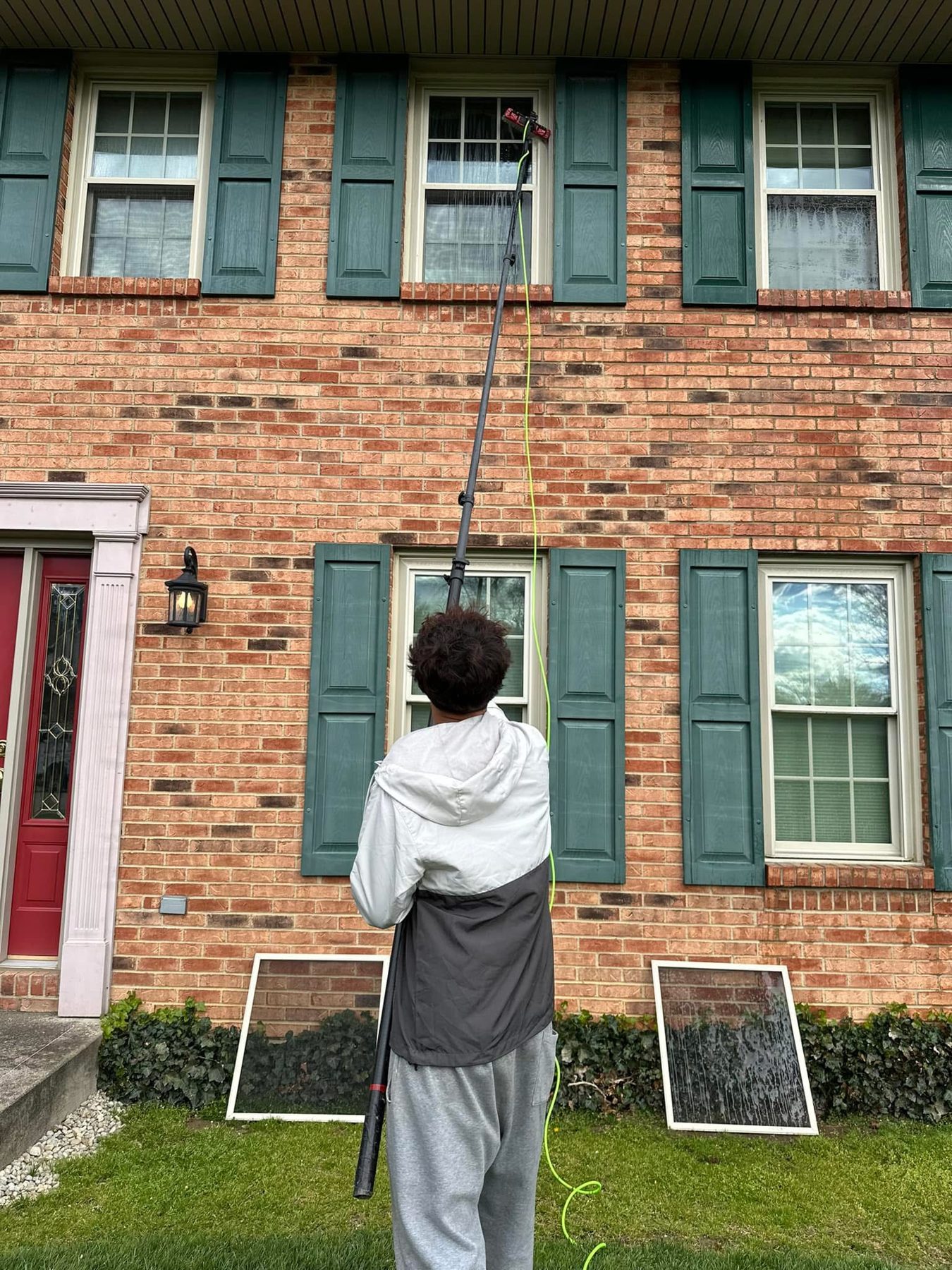 Water-fed pole window cleaning on a two story brick home in Cincinnati